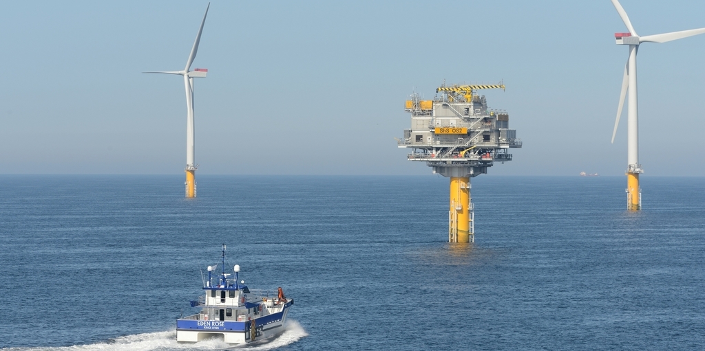 A support vessel approaches a construction platform in an offshore wind farm