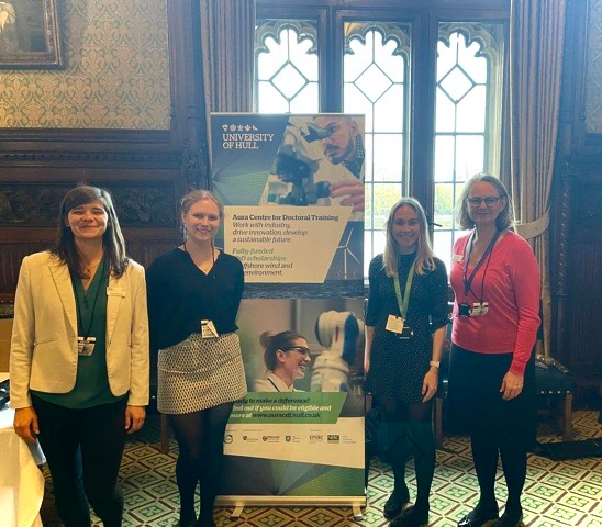 Dr Agota Mockute, Aura CDT students Rachael Keslake and Jordan Burgess stand with Aura Director, Louise Smith in the Houses of Parliament