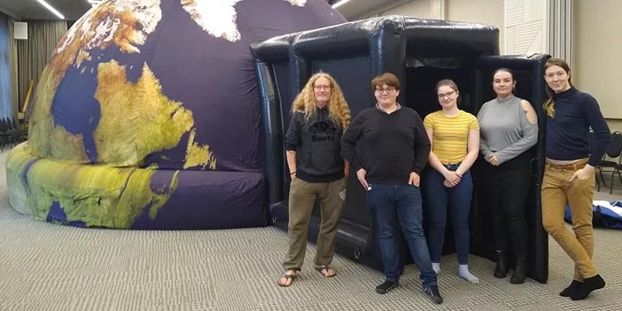 Daniel Whitts with Professor Brad Gibson and University of Hull Physics students with the inflatable planetarium