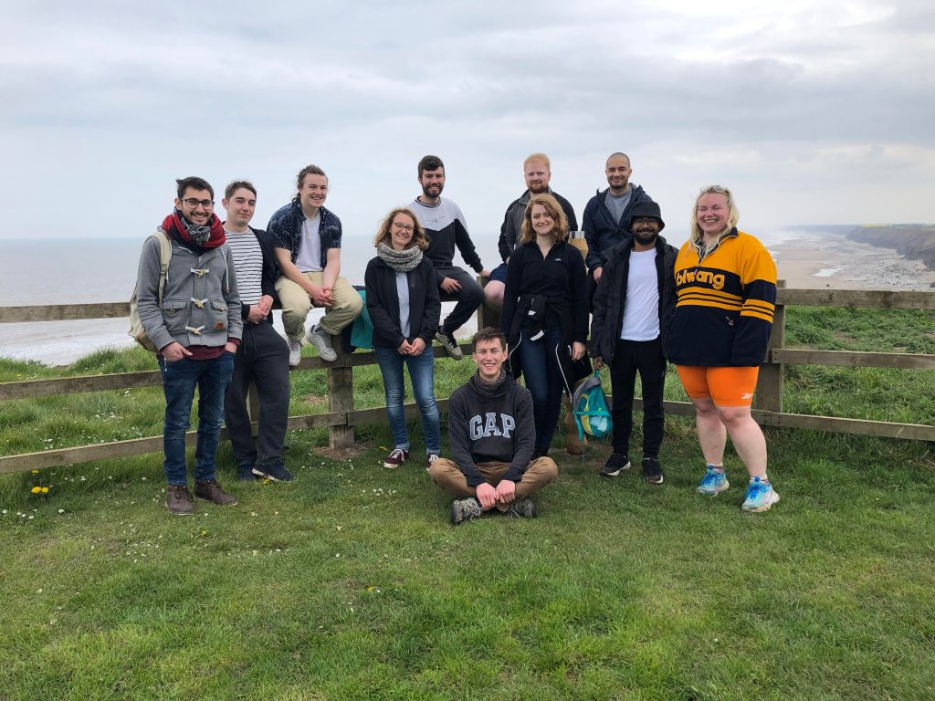 A group of students from the Aura CDT stand on the cliff tops near to Hornsea before taking part in a beach clean