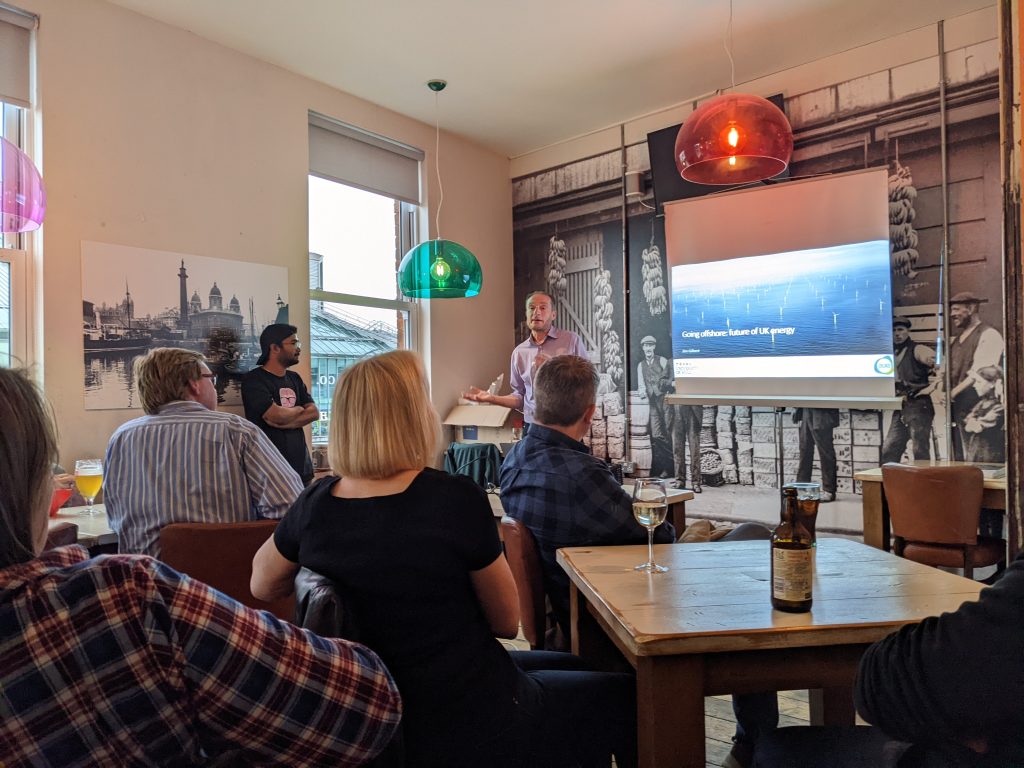 Prof Jim Gilbert addresses an audience seated at pub tables at this year's Pint of Science Festival