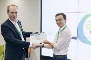 Aura CDT researcher, Simon Smith, receives her best student research presentation from Pete Osborne of the AMRC at the University of Sheffield