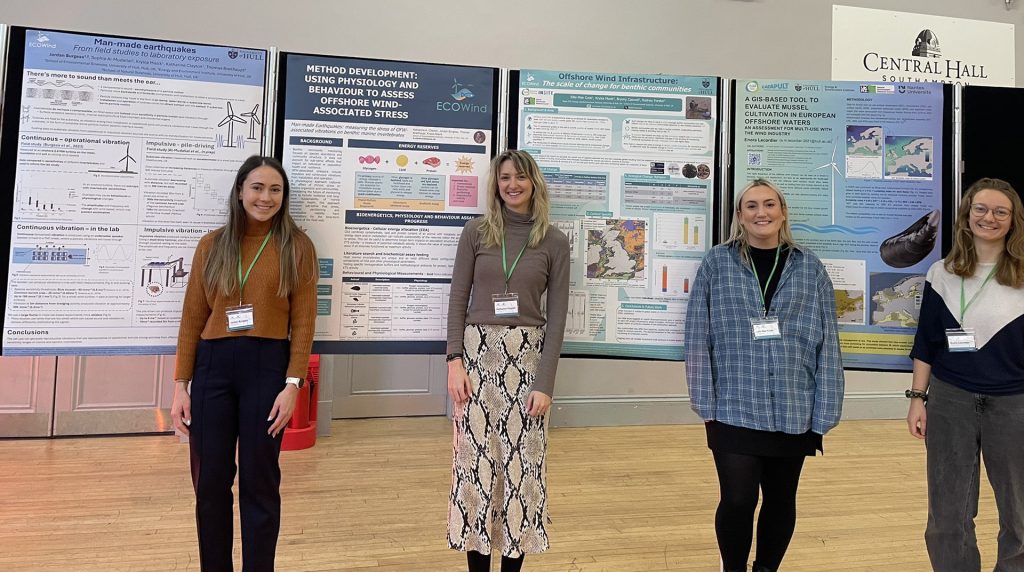 Three CDT researchers with their academic posters