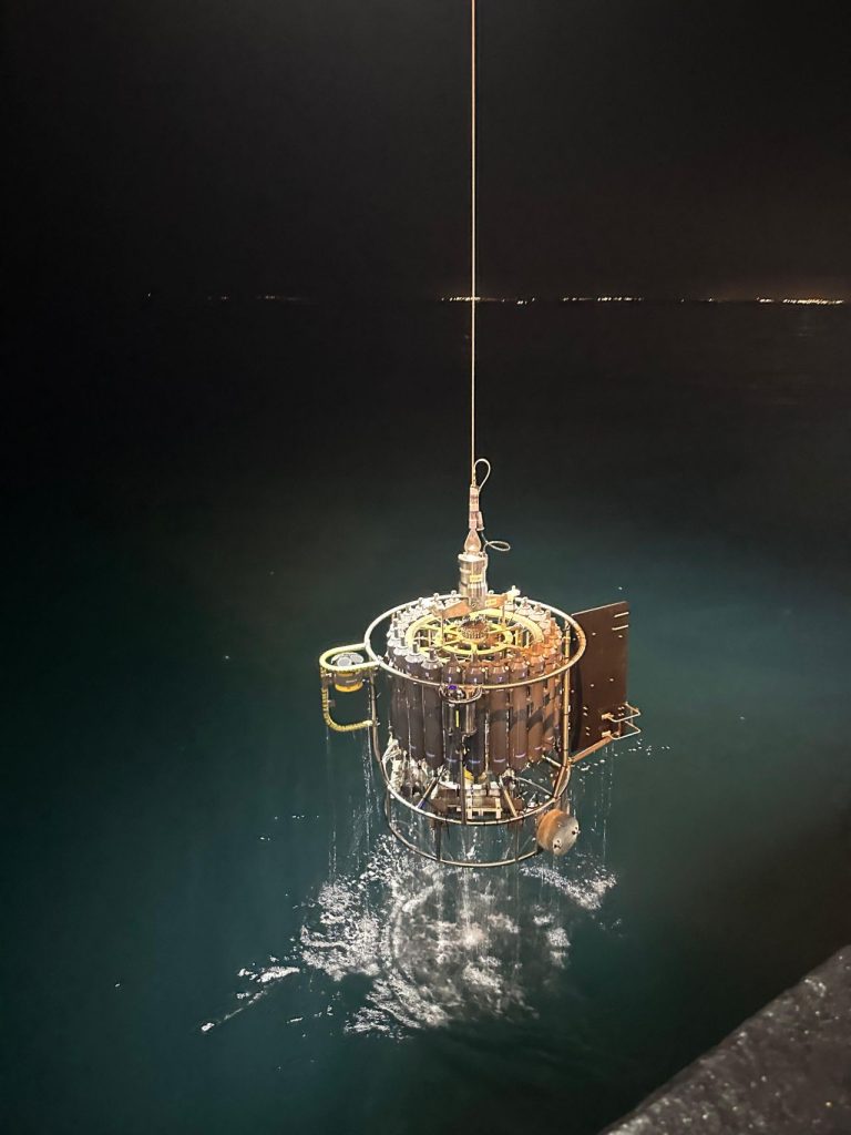 A collection device is pulled out of the sea at night