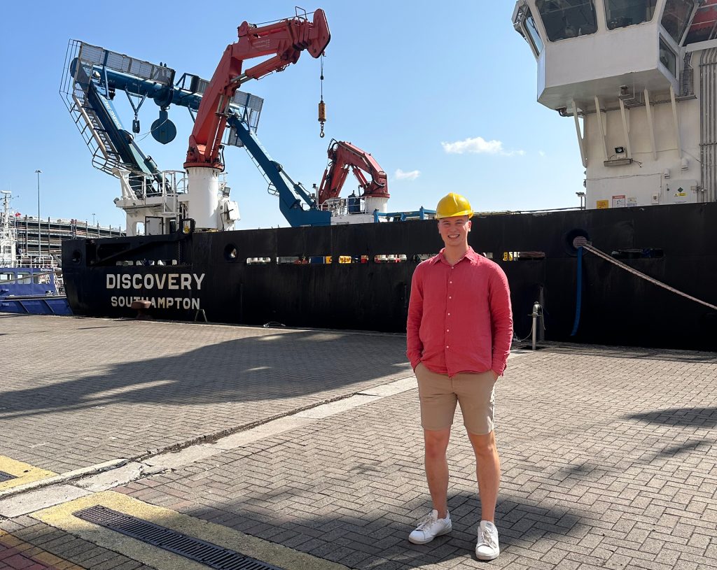 Ben Whitcombe next to the research vessel